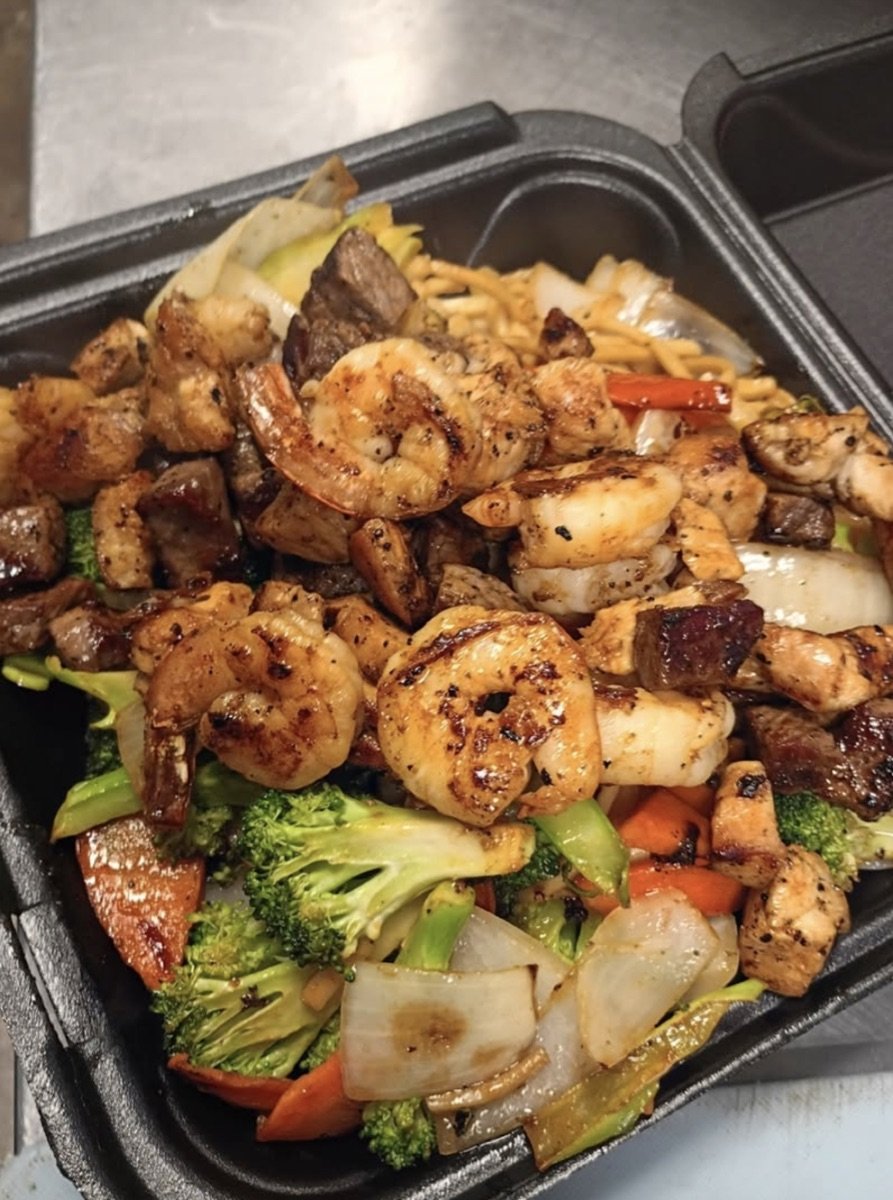 Massive Yahweh Tecan hibachi plate loaded with steak, shrimp, and vegetables