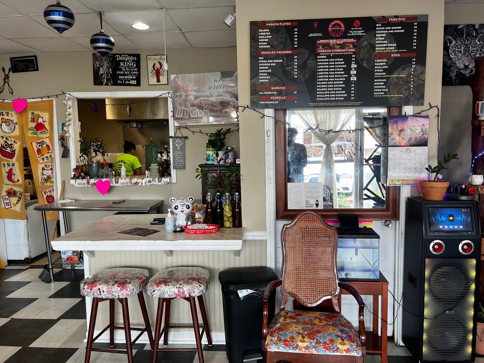 Yahweh Tecan restaurant interior with counter, menu board, and checkered floor